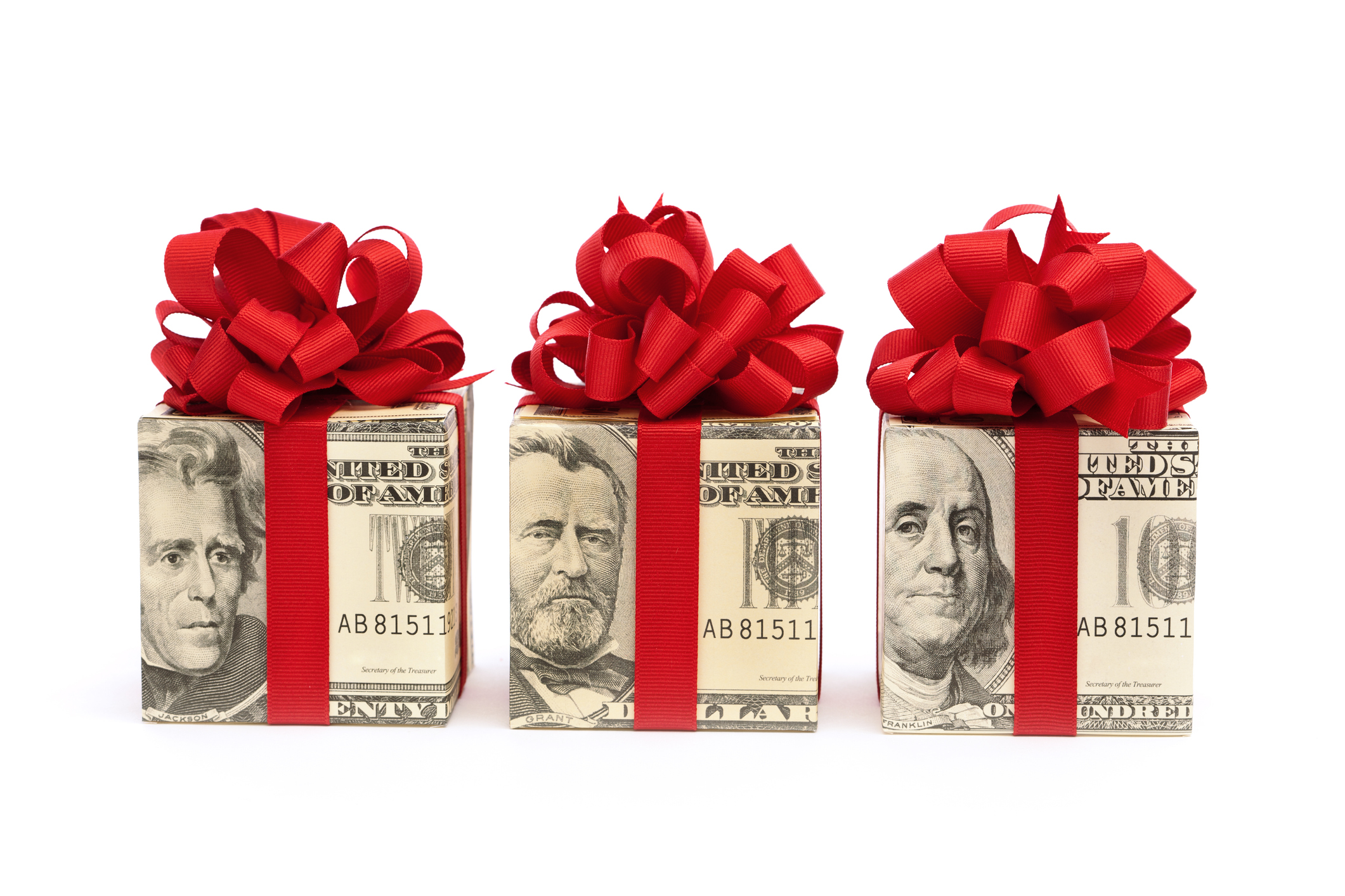3 gift boxes wrapped in money with a red bow around each box
